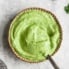 avocado lime sauce in a bowl with a spoon