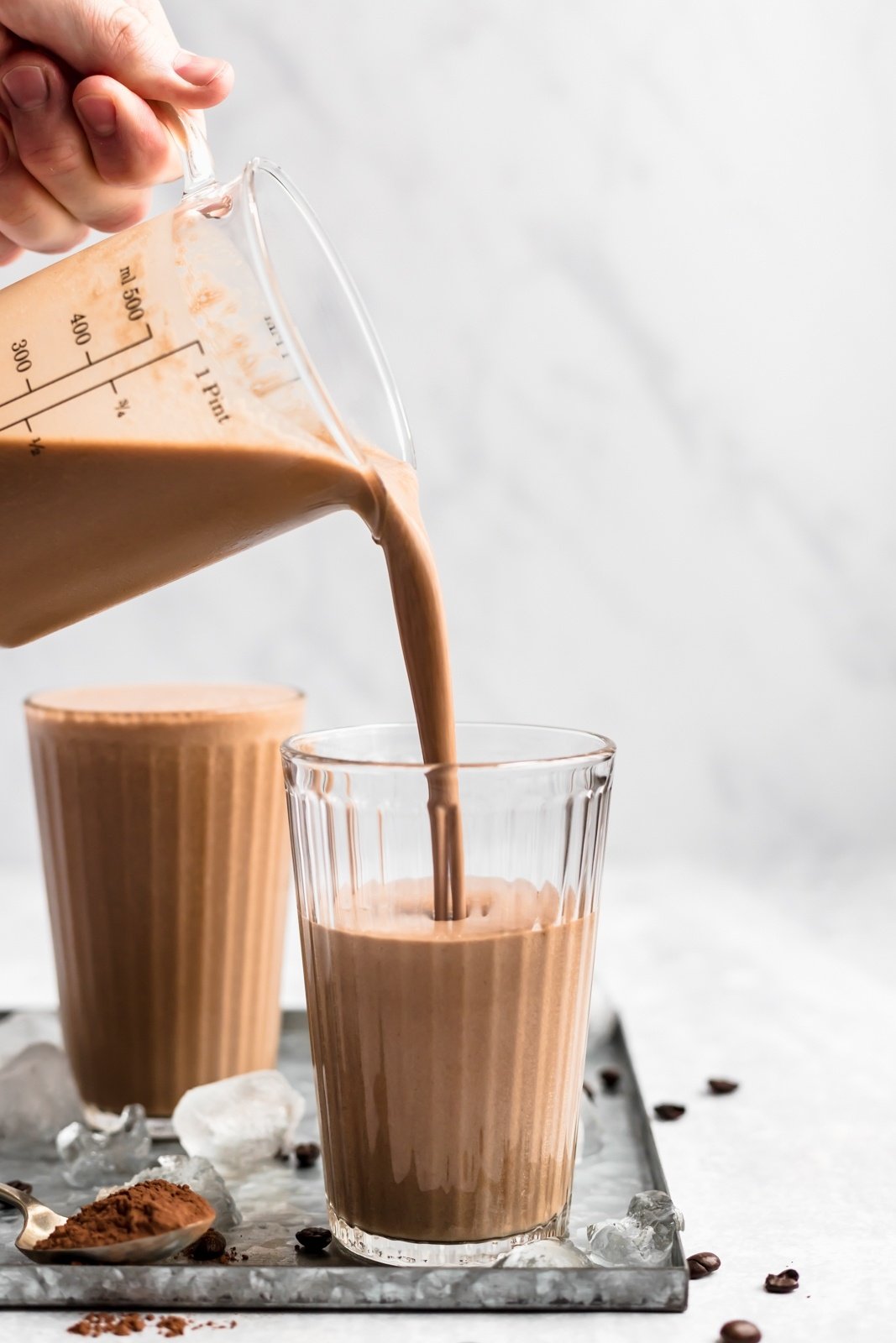 pouring a coffee smoothie into a glass