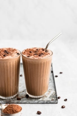 coffee smoothie in two glasses with metal straws
