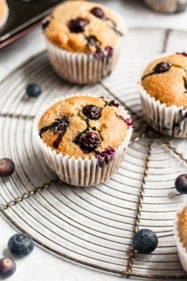 healthy blueberry oatmeal muffins on a round wire rack