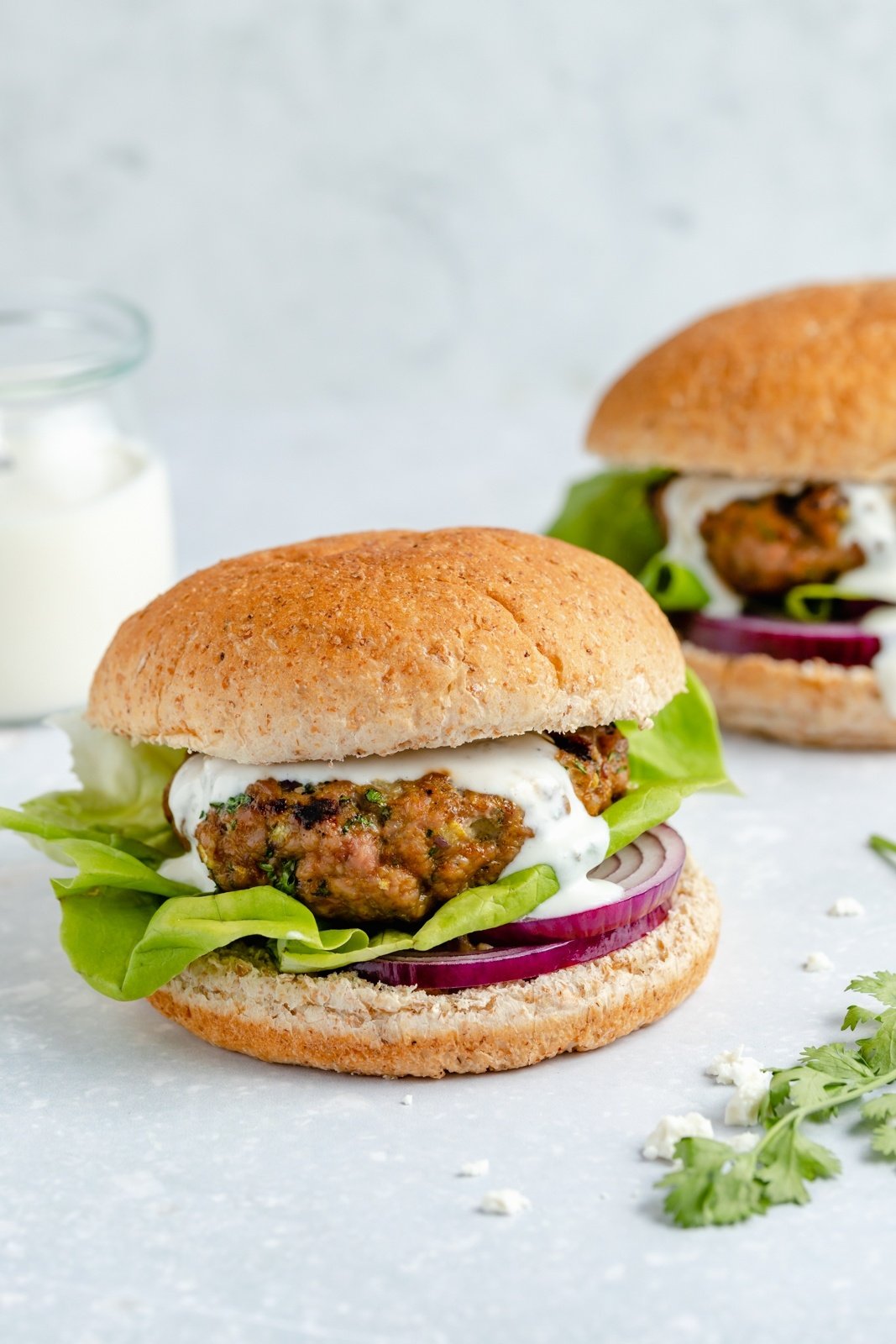 moroccan turkey burger topped with feta sauce, lettuce and red onion