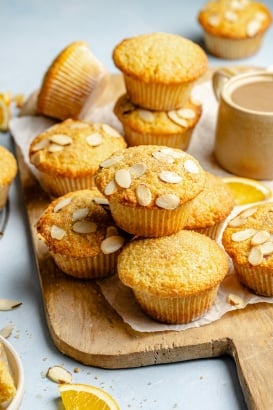 bakery-style orange muffins on a wooden board